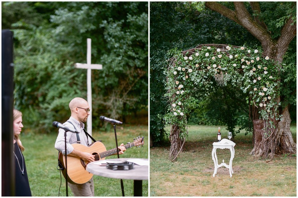 Guitarist singing at outdoor wedding ceremony by outdoor greenery archway