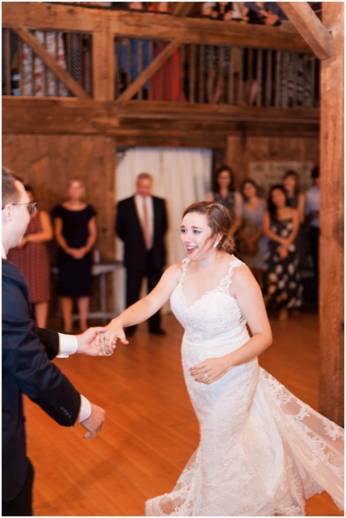 Bride dancing at reception wearing The Wedding Shoppe lace gown