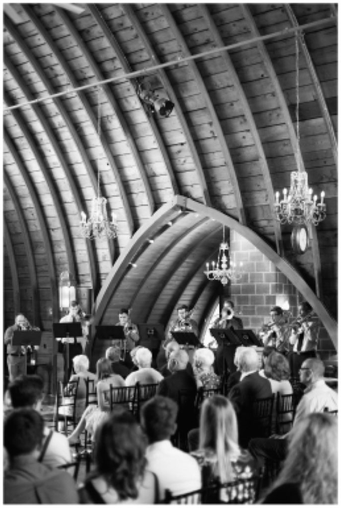 Trombone choir performing during indoor wedding ceremony at Green Acres Event Center in Eden Prairie, Minnesota
