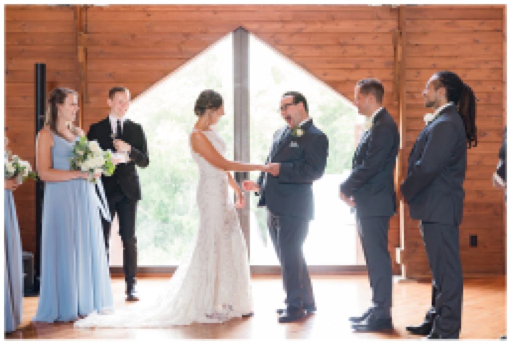 Joyful bride and groom celebrating being married at indoor wedding in Eden Prairie, Minnesota.