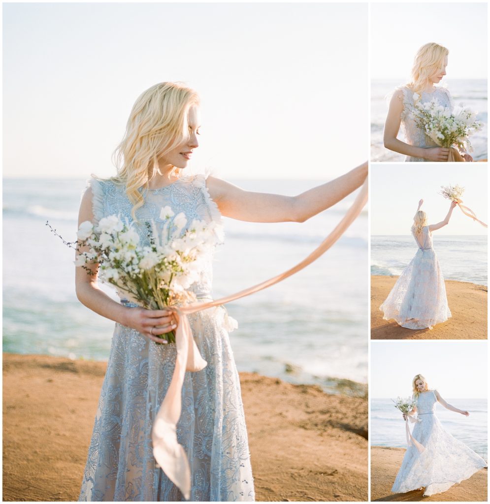 Holding a white floral bouquet by Max Owens Design, a bride stands on the beach at sunset for a series on fine art portraits showcasing her light, ocean blue wedding gown, by Christina Sfez.