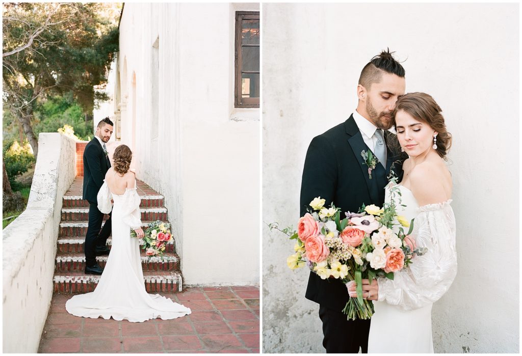Fine art photography portraits of bride and groom, bride is wearing Alexandra Grecco spring gown and holding an Oak and the Owl floral arrangement outside white building.