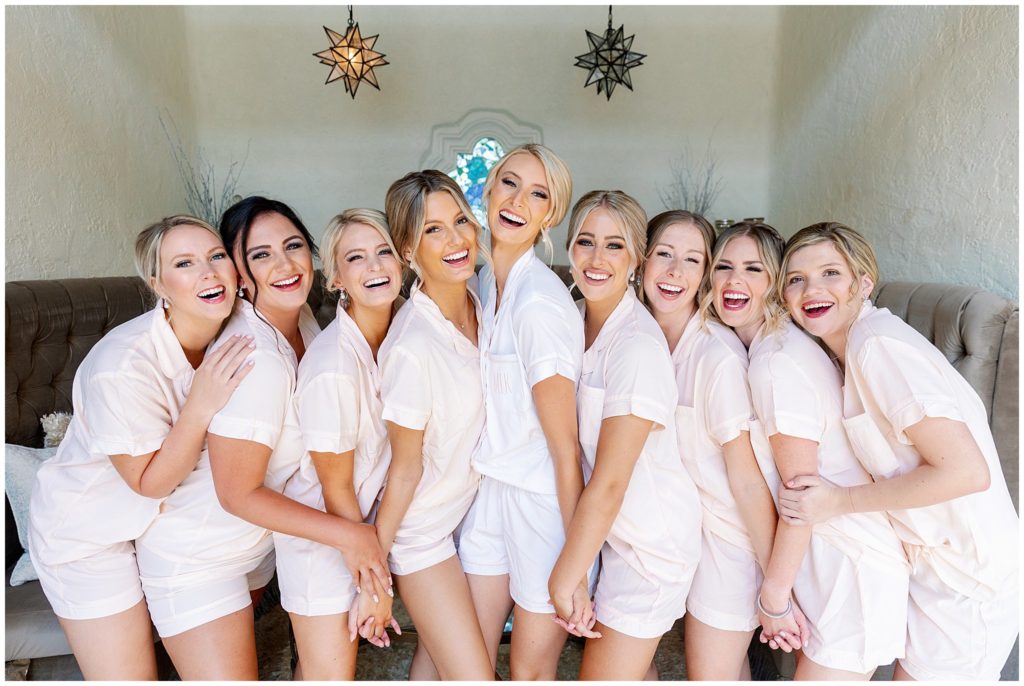 Bride and bridesmaids gather together for matching pajama photo