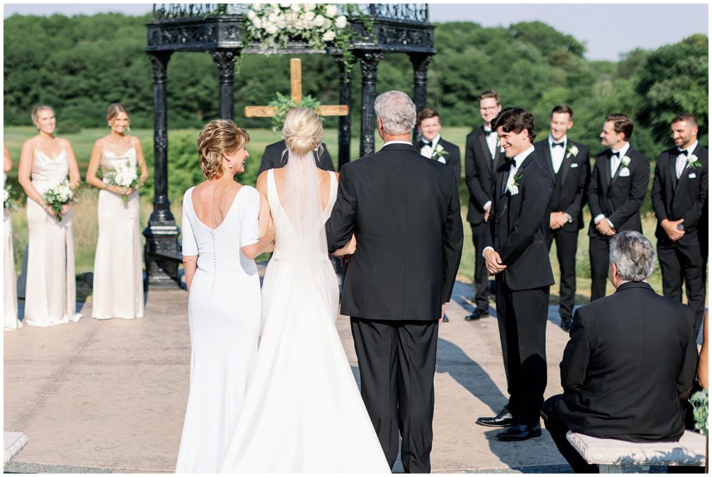 Minnesota bride walks down aisle during outdoor wedding ceremony