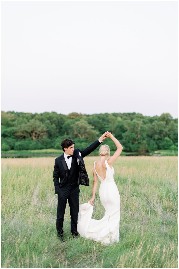 The Beys Photo summer wedding where bride and groom dance in a green field at Bavaria Downs Edward Anne Estate