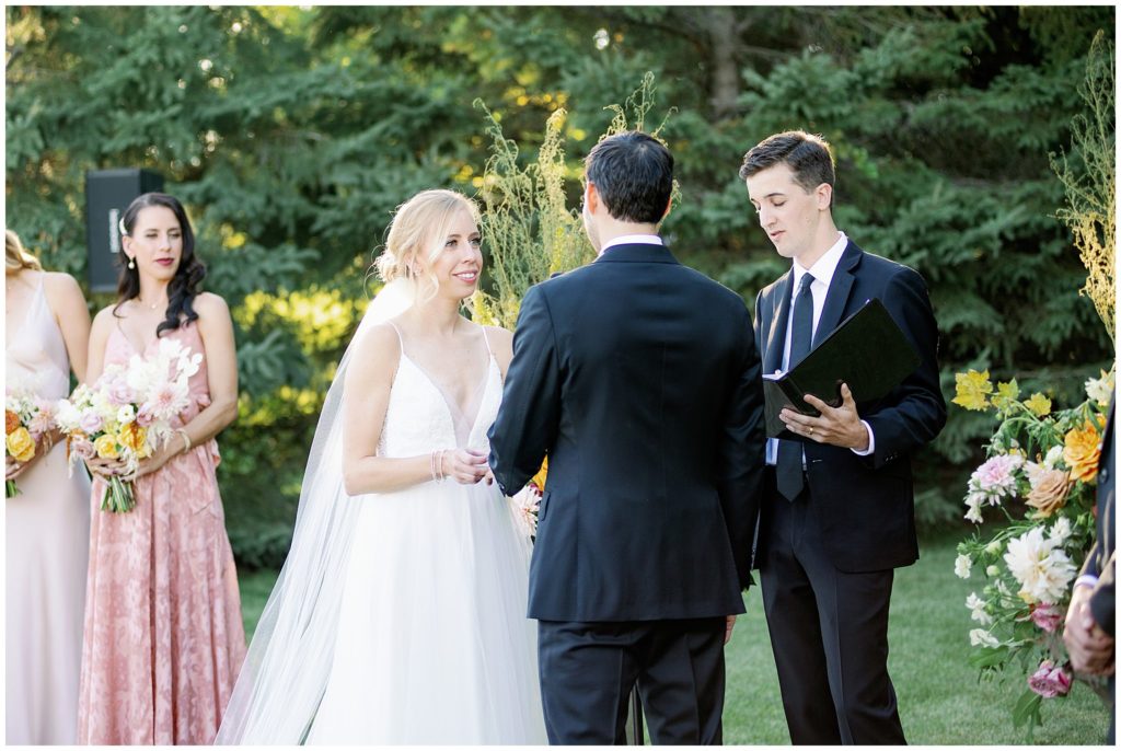 Bride and groom at outdoor wedding ceremony in Minnesota at estate