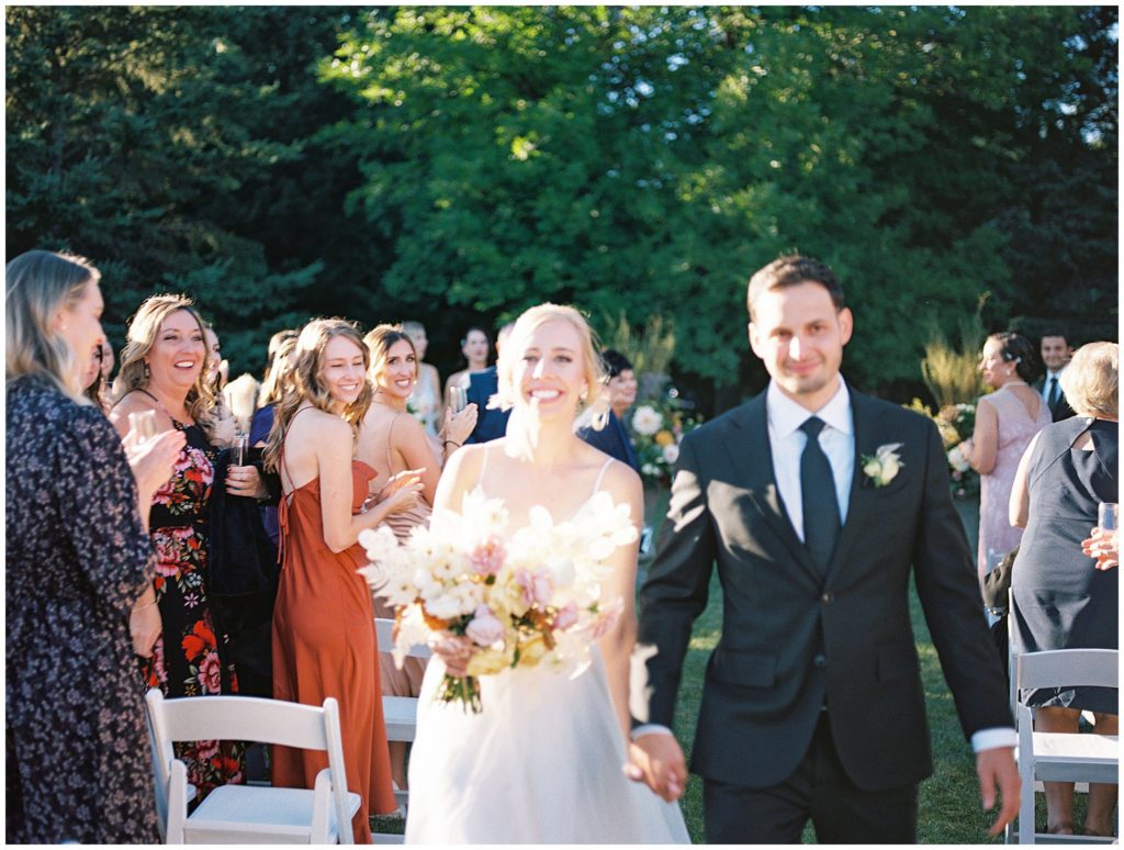 Film image of recessional from Minnesota wedding at an estate